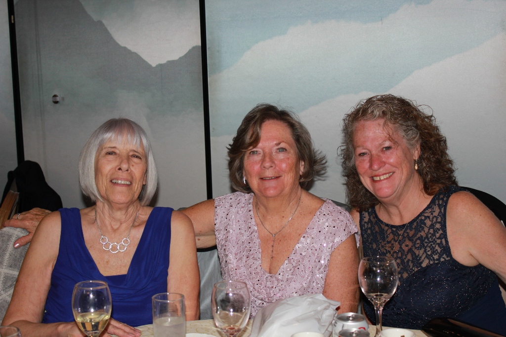Three ladies smiling at the event